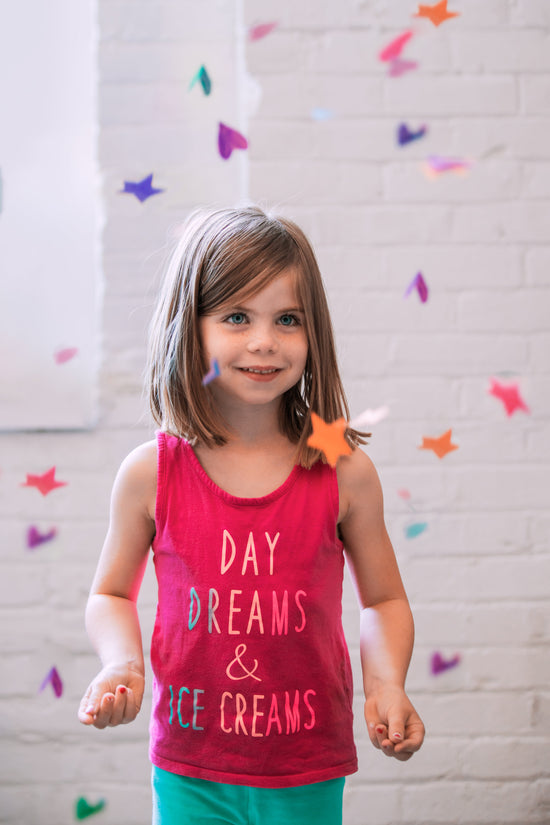 A girl smiles as colorful confetti falls around her. | LunaSola Designs, LLC