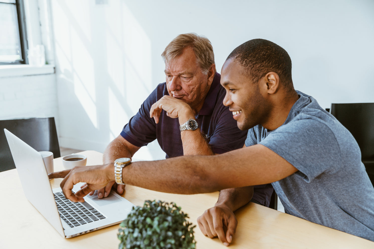 A young man assists an older man on a computer. Education in technology at all ages is so important. | Helping others accomplish their dreams and goals.  Bringing their ideas and vision to life.  | LunaSola Designs