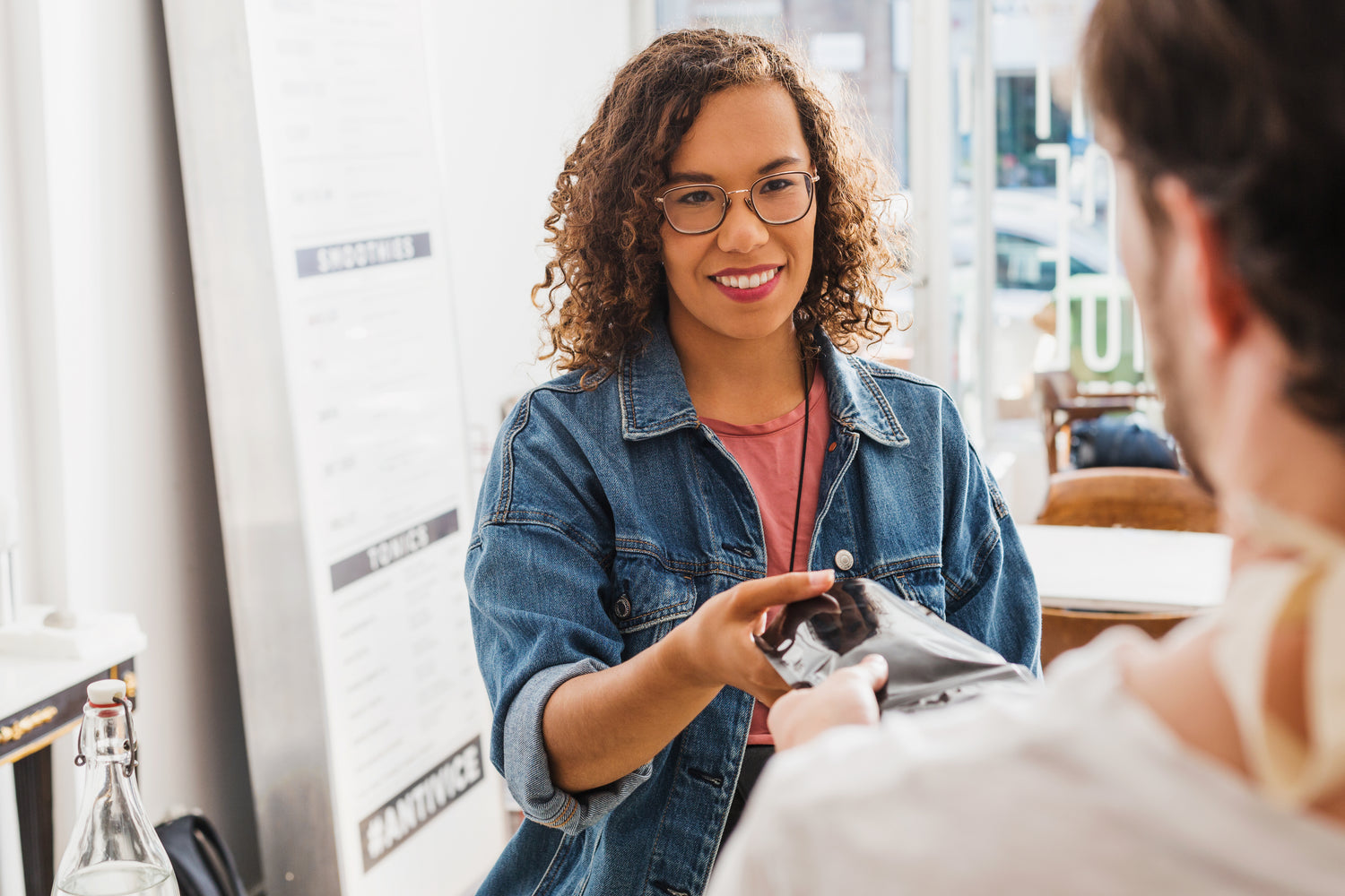 A woman hands her item to the cashier with a smile. | Our online storefront is for your enjoyment.  Find the perfect item for your needs.  Niche and specialty items.  Support local business.  Support small business. | LunaSola Designs